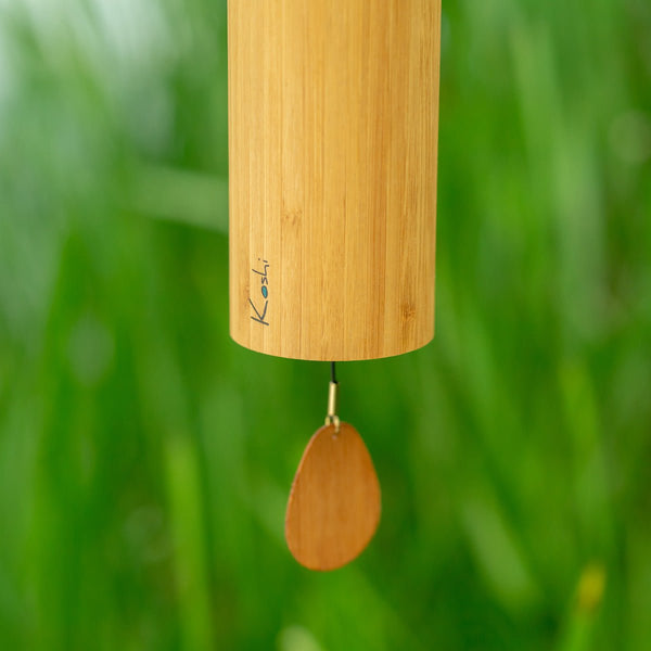 Close-up of Koshi Aqua wind chime showing precision-welded metal rods and bamboo tube detail