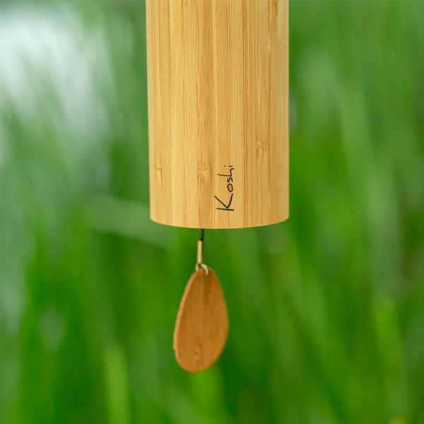 Close-up of Koshi Aria wind chime showing precision-welded metal rods and bamboo tube detail